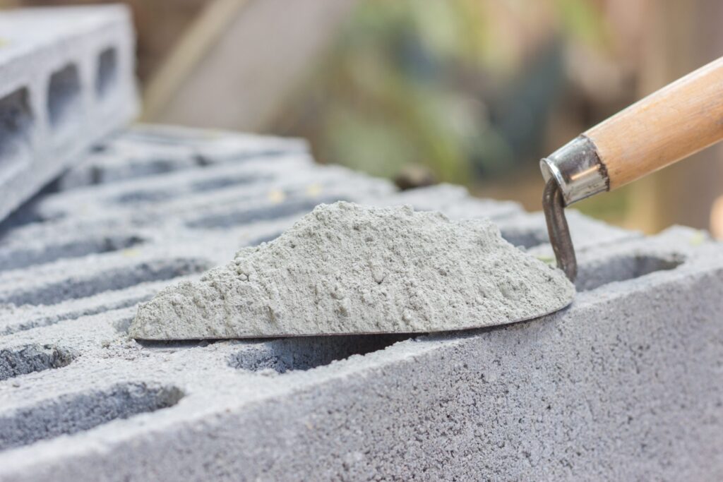 cement powder with trowel put brick construction work scaled
